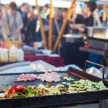 Chef making chicken with grilled vegetable tortilla wrap outdoor on street stall on Open kitchen...