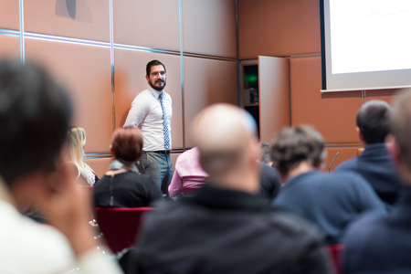 Relaxed Businessman Giving a Talk at Informal Business Meeting. Audience in the conference hall. Business and Entrepreneurship concept.の写真素材