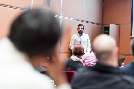 Relaxed Businessman Giving a Talk at Informal Business Meeting. Audience in the conference hall. Business and Entrepreneurship concept.の写真素材