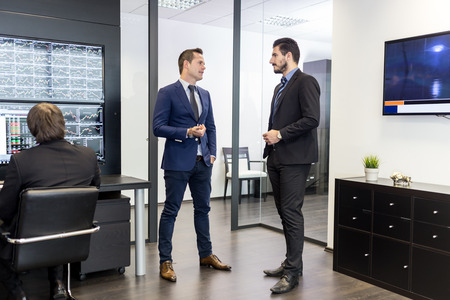 Corporate business people meeting and working in modern office. Project manager and his team discussing business strategy. Business and entrepreneurship concept.の写真素材