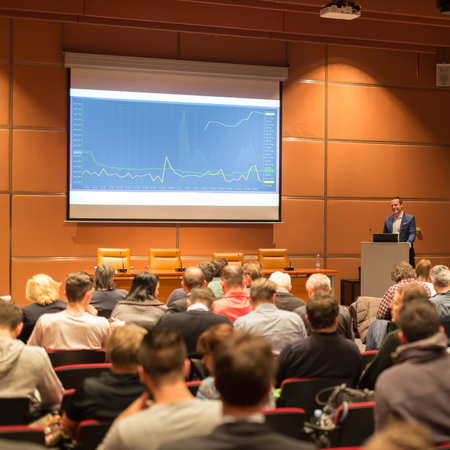 Speaker giving a talk in conference hall at business event. Audience at the conference hall. Business and Entrepreneurship concept.の写真素材