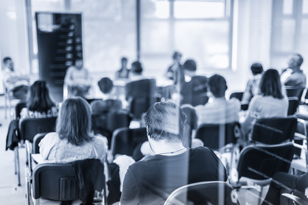 Round table discussion at Business convention and Presentation. Audience at the conference hall. Business and entrepreneurship symposium. Black and white blue toned image.の写真素材