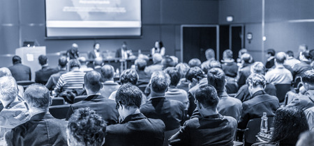 Round table discussion at Business convention and Presentation. Audience at the conference hall. Business and entrepreneurship symposium. Black and white blue toned image.の写真素材