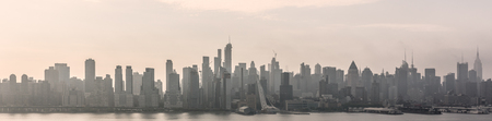 New York City midtown Manhattan skyline panorama view from Boulevard East Old Glory Park over Hudson River on a misty morning.の写真素材