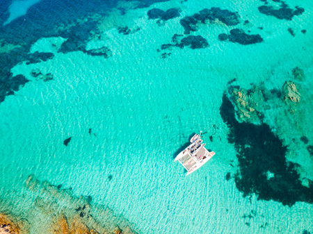 Drone aerial view of catamaran sailing boat in Maddalena Archipelago, Sardinia, Italy. Maddalena...