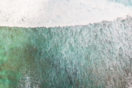 Aerial shot of the braking wave at the ocean reef.の写真素材