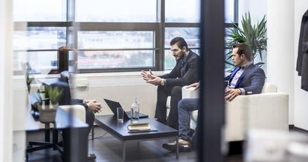 Business people sitting at working meeting in modern corporate office. Business and entrepreneurship concept.の写真素材