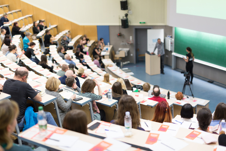 Conference and Presentation. Audience at the conference hall. Business and Entrepreneurship. Faculty lecture and workshop. Audience in the lecture hall. Academic education. Participants making notes.の写真素材