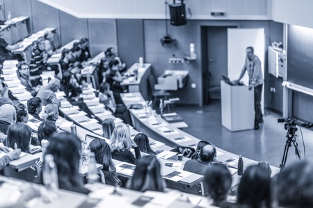 Conference and Presentation. Audience at the conference hall. Business and Entrepreneurship. Faculty lecture and workshop. Audience in the lecture hall. Academic education. Participants making notes.の写真素材