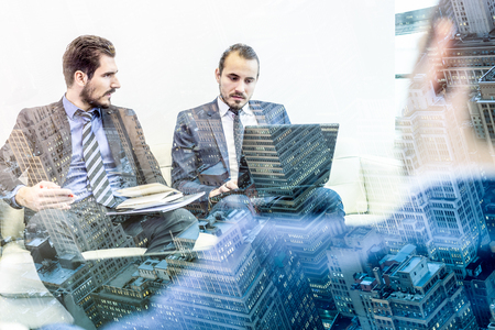 Corporate business team and manager at business meeting. Project management team working in office. Business and entrepreneurship concept. New York City buildings and skyscrapers reflection in glass.の写真素材