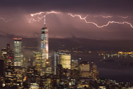 Artistic motion blured image of New York City skyline with lower Manhattan skyscrapers in lightning...