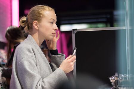 Women buying and testing cosmetics in a beauty store.の写真素材