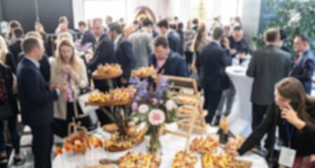 Abstract blurred photo of business people socializing during banquet lunch break break at business meeting, conference or event.の写真素材