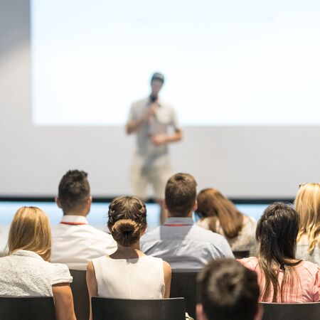 Business and entrepreneurship symposium. Speaker giving a talk at business meeting. Audience in...