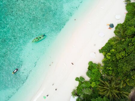 Aerial  view of picture perfect beach and turquoise lagoon on small tropical island on Maldives.の写真素材