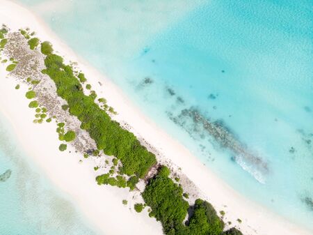 Aerial  view of picture perfect beach and turquoise lagoon on small tropical island on Maldives.の写真素材
