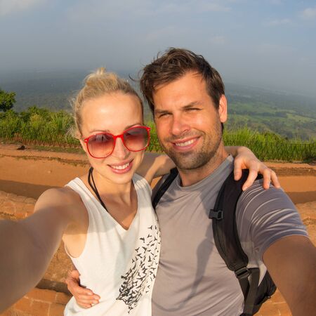 Young beautiful couple making vacation selfie traveling at Sigiriya Fortres, Lion Rock, Sri Lanka.の写真素材