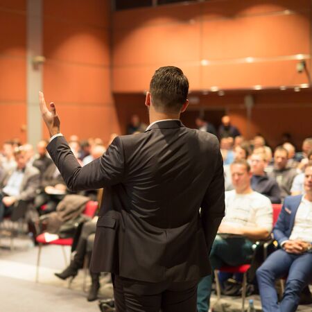 Speaker giving a talk on corporate business conference. Audience at the conference hall. Business and entrepreneurship event.の写真素材