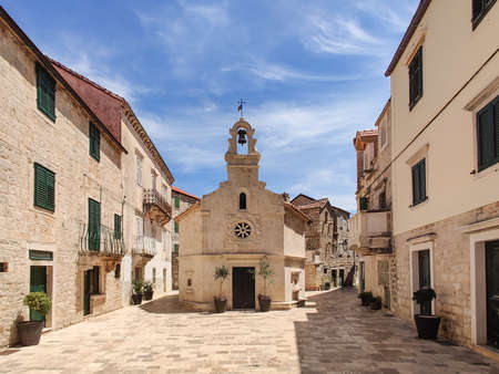 Small church on square of small urban village of Stari grad on Hvar island in Croatia, Adriatic Sea, Europe.の写真素材