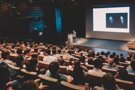 Business speaker giving a talk in conference hall.の写真素材