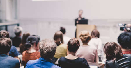 Woman giving presentation on business conference event.の写真素材