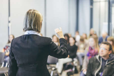 Female public speaker giving talk at Business Event.の写真素材
