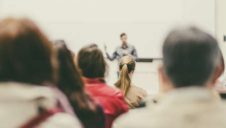 Man giving presentation in lecture hall at university.の写真素材