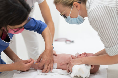 Baby beeing vaccinated by pediatrician in presence of his mother. Preventive vaccination against...