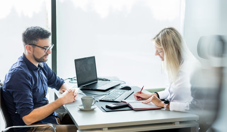Business meeting. Client consulting. Confident business woman, real estate agent, financial advisor explaining details of project or financial product to client in officeの写真素材