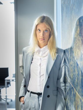 Portrait of Fashionably Dressed Pretty Business Woman Standing in Office Hallの写真素材