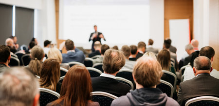 Speaker giving a talk in conference hall at business event. Rear view of unrecognizable people in audience at the conference hall. Business and entrepreneurship conceptの写真素材