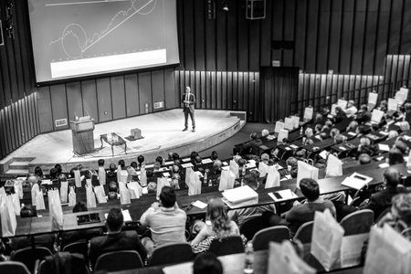 Speaker Giving a Talk at Business Meeting. Audience in the conference hall. Business and Entrepreneurship concept. Black and white image.の写真素材