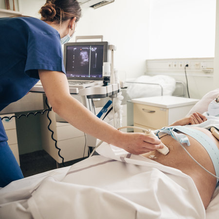 Prenatal medical exam. Female doctor using ultrasound scanner for gynecologist telling and showing...