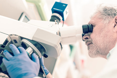 Senior head scientist microscoping in the life science research laboratory ( diagnostics, biochemistry, pharmacy, genetics, forensics, microbiology, pharmacogenetics ...)の写真素材