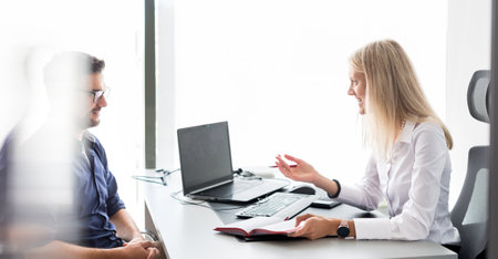 Business meeting. Client consulting. Confident business woman, real estate agent, financial advisor explaining details of project or financial product to client in officeの写真素材