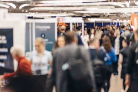 Abstract blurred people at exhibition hall of expo event trade show. Business convention show or job fair. Business concept backgroundの写真素材