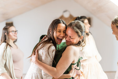 Group of cheerful women all ages, happy people dancing together wearing traditional colorful dresses and hippy clothes. Free people enjoying leisure activity, emphasizing friendship, fun, movement.の写真素材