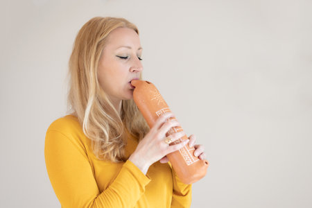Portrait of female musician playing on traditional clay flute. Woman playing ocarinaの写真素材