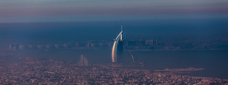 Skyline of Dubai beachfront with Burj Al Arab hotel on Jumeirah beach seen from Burj Khalifa...