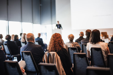 Speaker giving a talk in conference hall at business event. Rear view of unrecognizable people in audience at the conference hall. Business and entrepreneurship conceptの写真素材