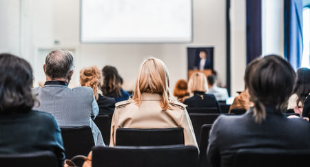 Speaker giving a talk in conference hall at business event. Rear view of unrecognizable people in audience at the conference hall. Business and entrepreneurship conceptの写真素材