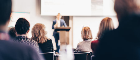 Speaker giving a talk in conference hall at business event. Rear view of unrecognizable people in audience at the conference hall. Business and entrepreneurship conceptの写真素材