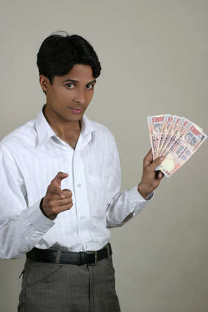 successful young indian with moneyの写真素材