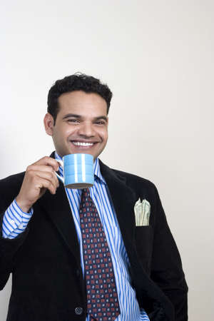 portrait of successful relaxed Indian having coffeeの写真素材