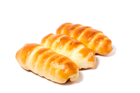 flour product, fresh buns, isolate, three sausages in the doughの写真素材