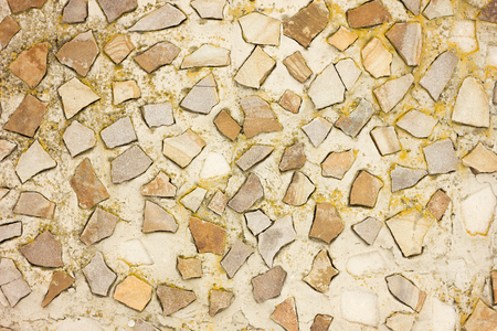 texture of small stones on concrete, stone savage laid out on concrete in a chaotic mannerの写真素材