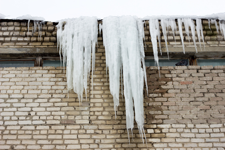 big icicle on the roof of a building, a social problemの写真素材