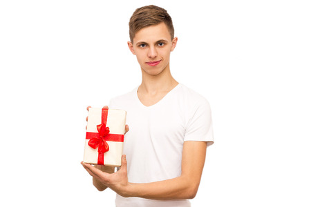 portrait of a guy with a gift, isolate, the guy in a white T-shirt gives a giftの写真素材