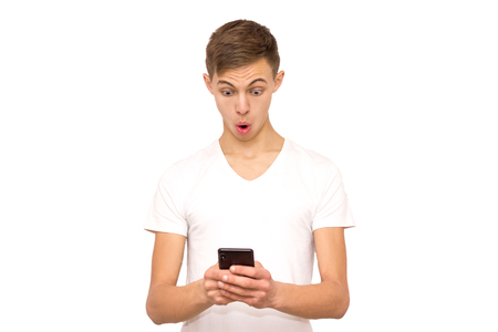 surprised guy with phone, isolate, man on white background in studioの写真素材