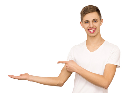 guy in white t-shirt shows advertising, isolate advertising teenager on white backgroundの写真素材